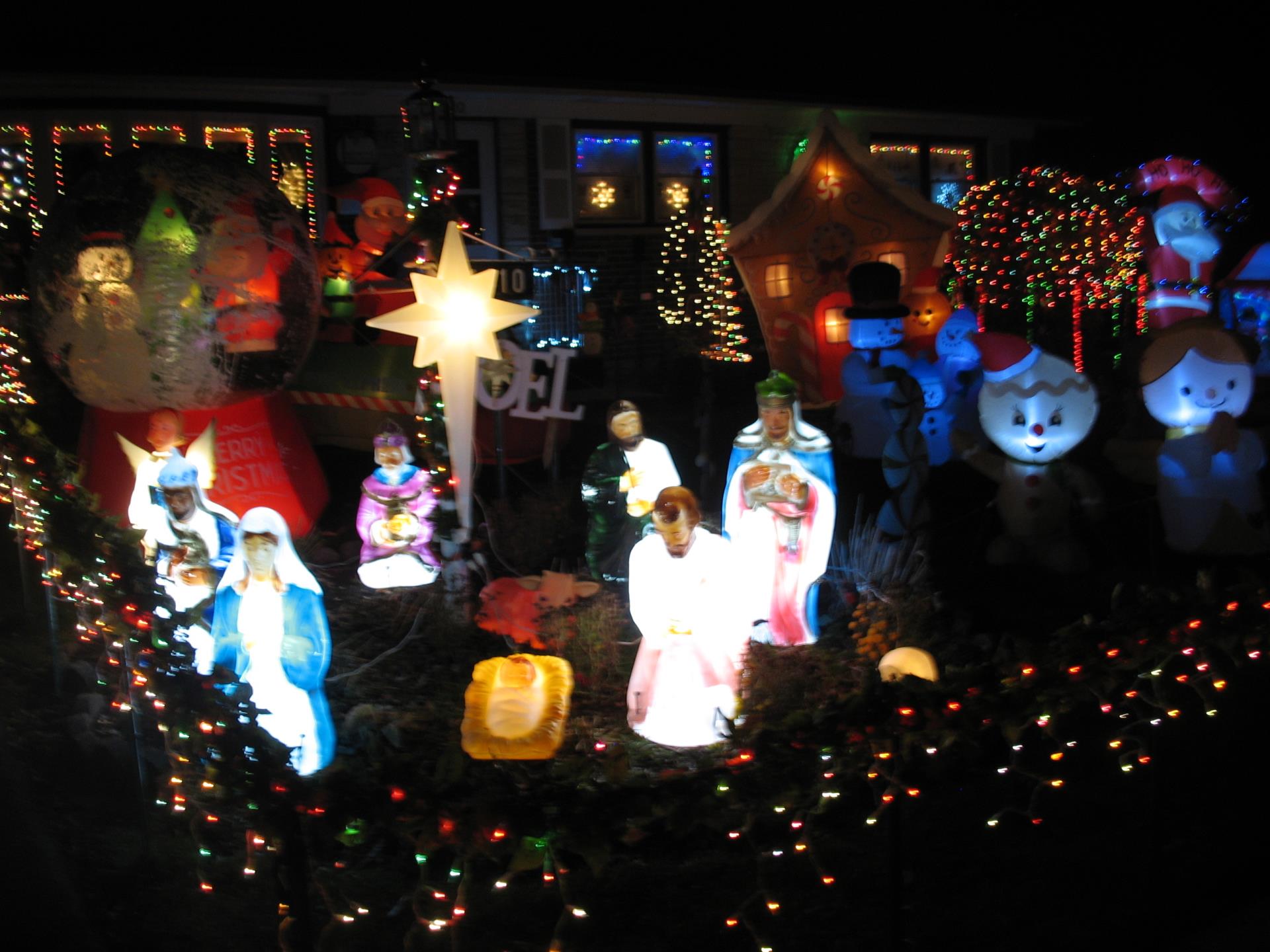 A house front yard adorned with colorful Christmas lights
